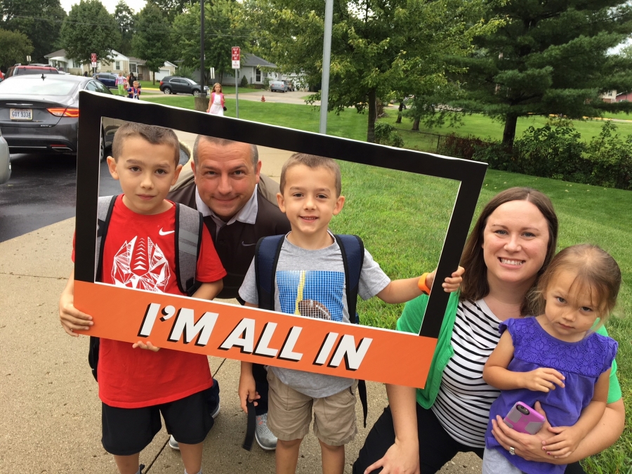 people holding a frame sign